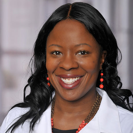 Headshot photograph of J. Nwando Olayiwola, MD, MPH, FAAFP, a black woman wearing a physician white coat smiling.