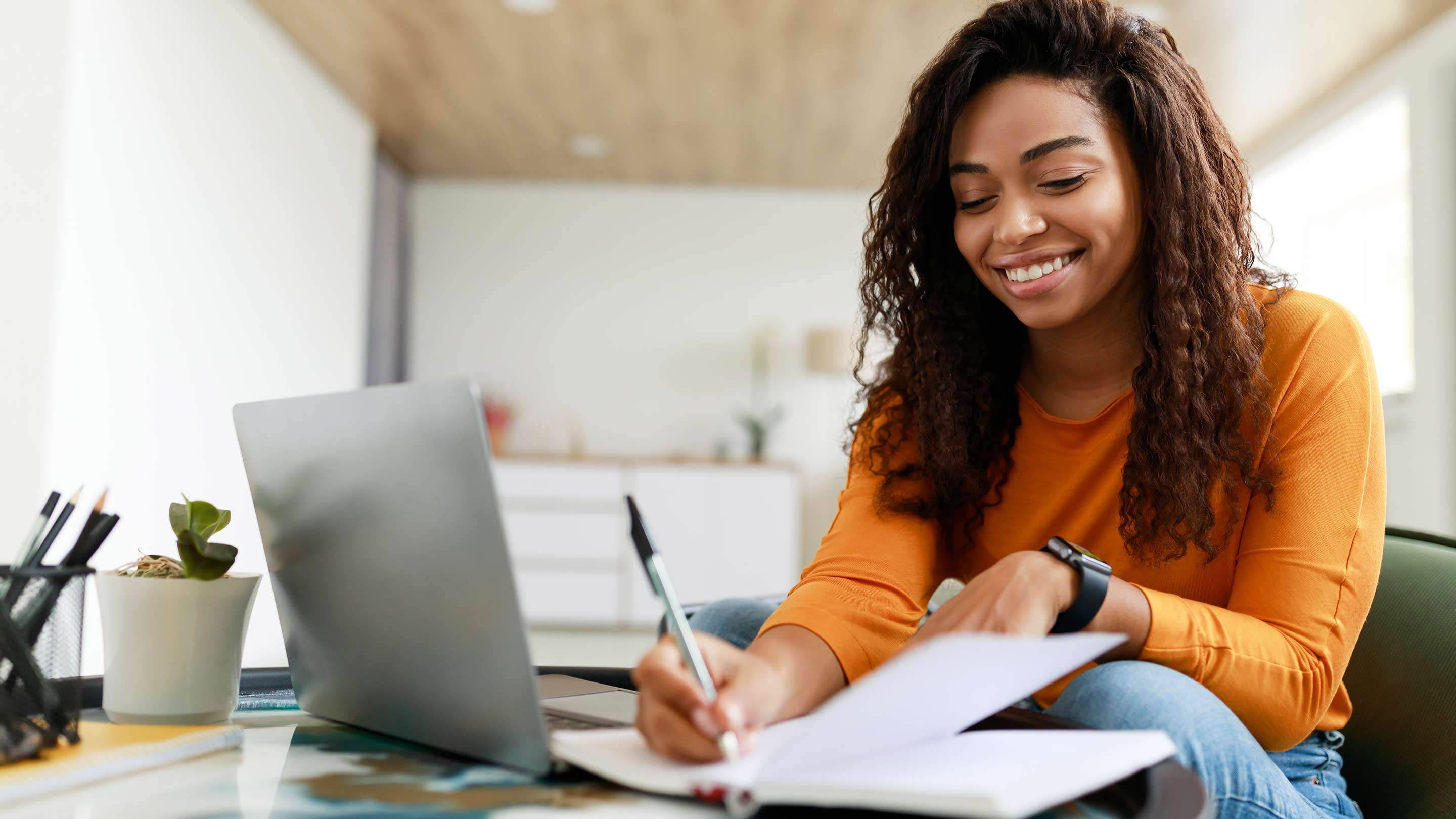 A student studying for a test while seated at a table at home.