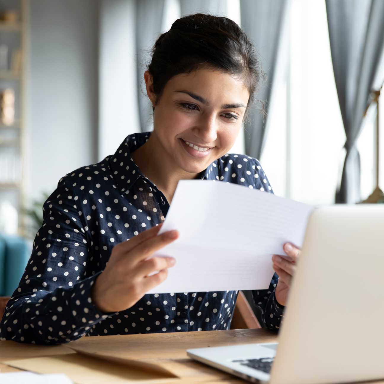 A young woman reading a letter
