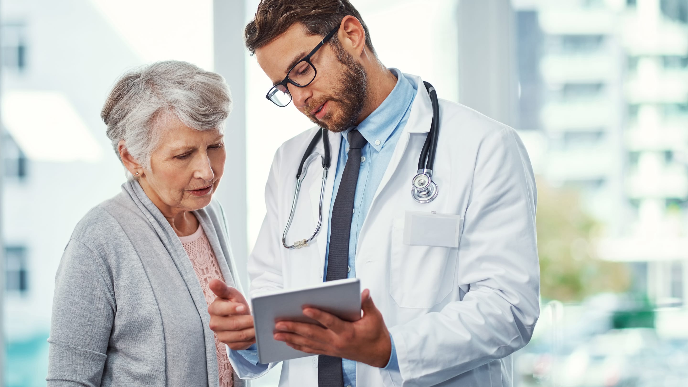 Physician in a conversation with older patients.