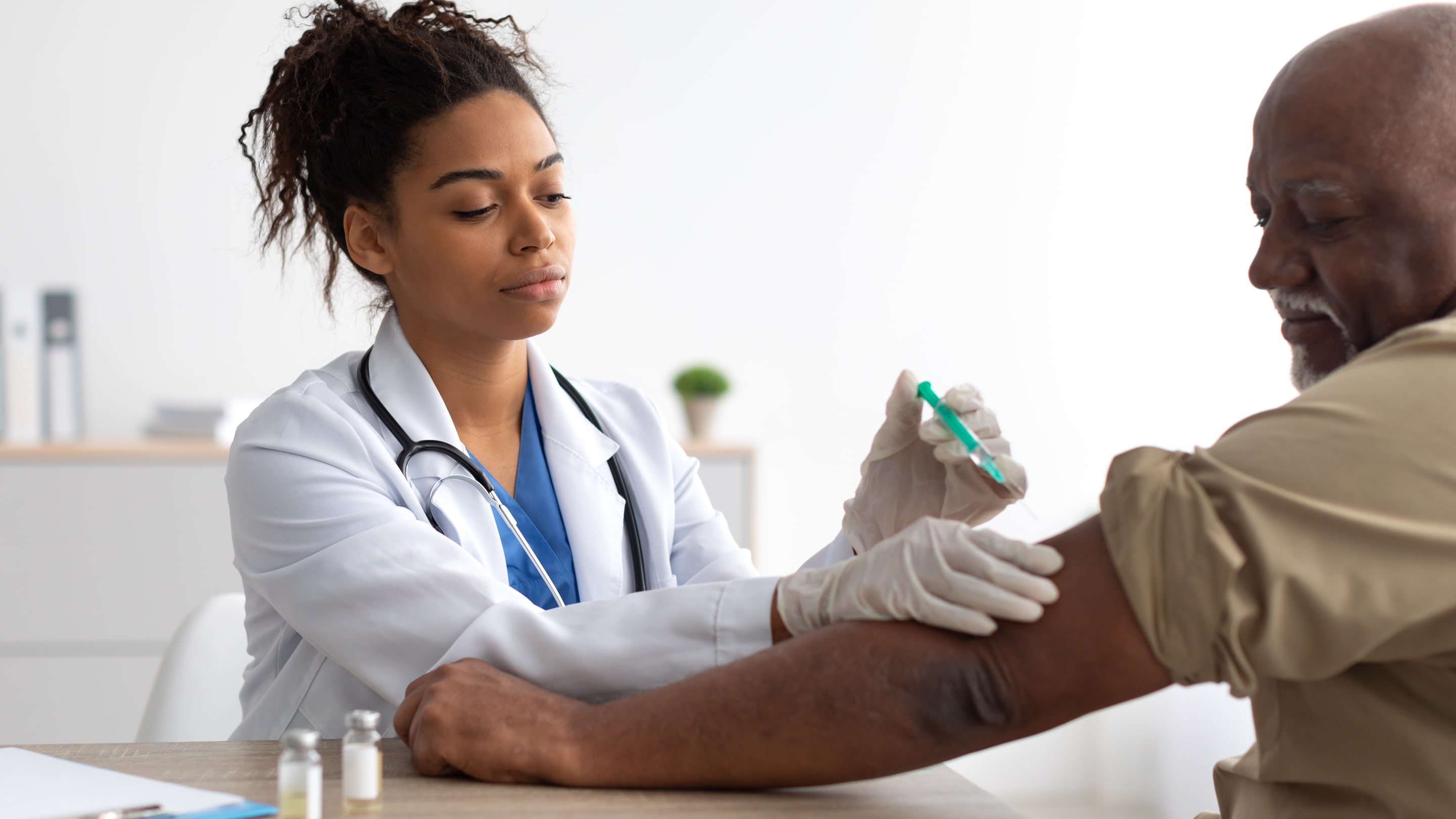 Physician providing a vaccine to a patient.