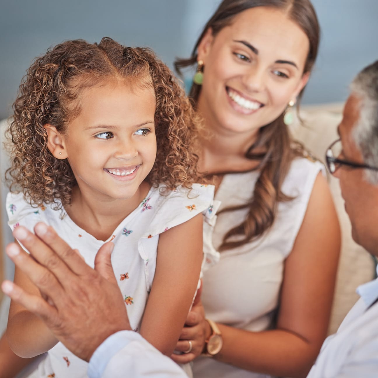 Image of doctor interacting with a mother and young daughter.