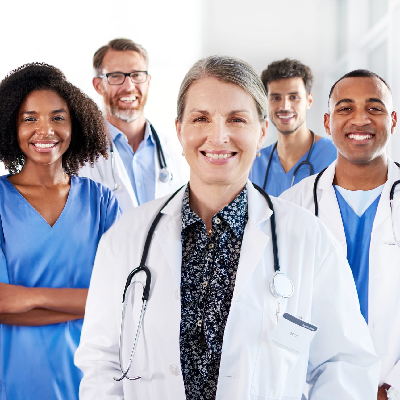 Image of a group of doctors smiling and looking at the camera.