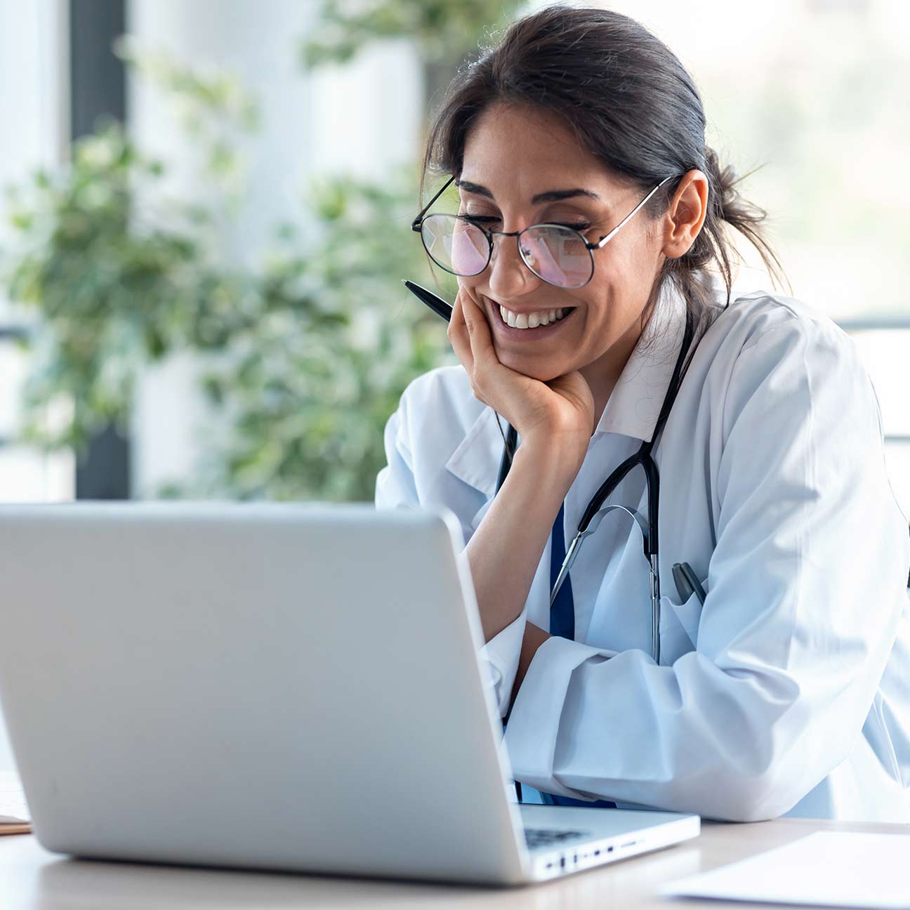Shot of smiling female doctor working with her laptop.