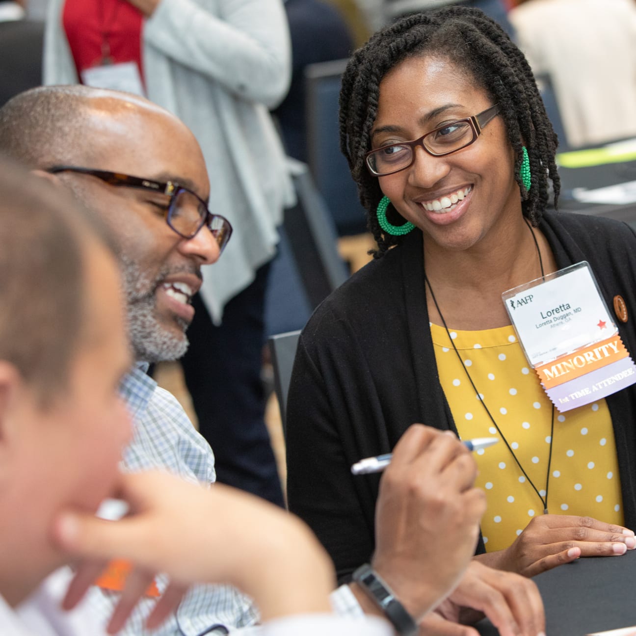 Image from NCCL of attendees collaborating at a table.
