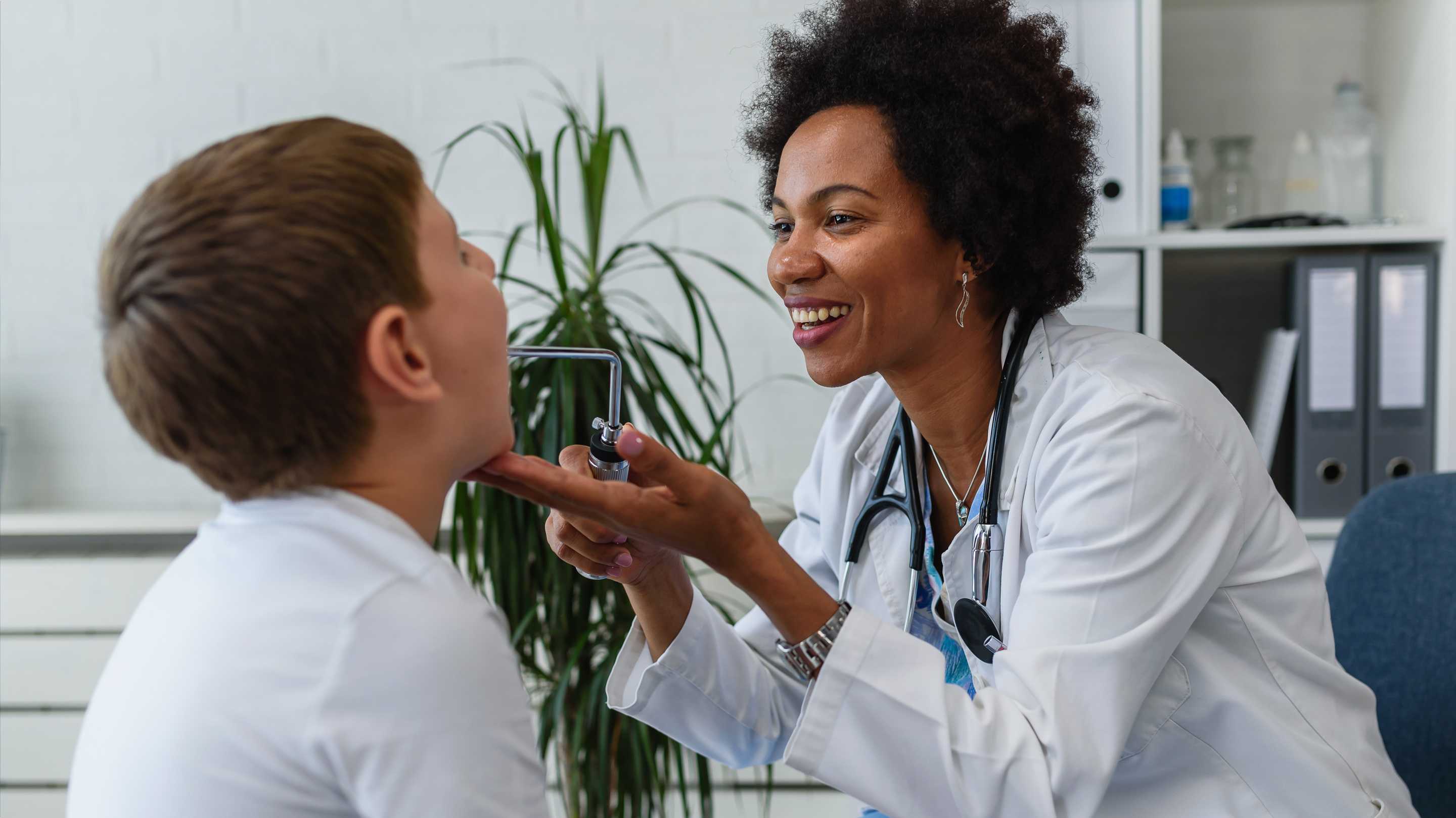 Family physician examining a young child in a clinical setting