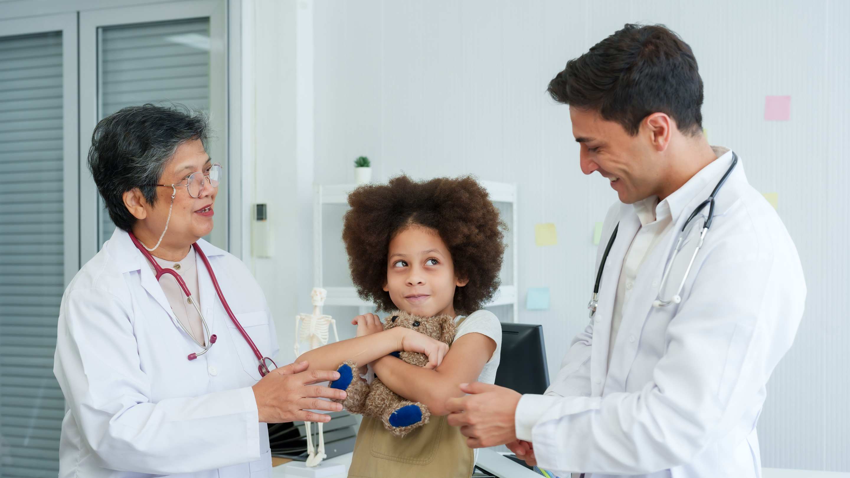 Family medicine team discusses patient care in clinic