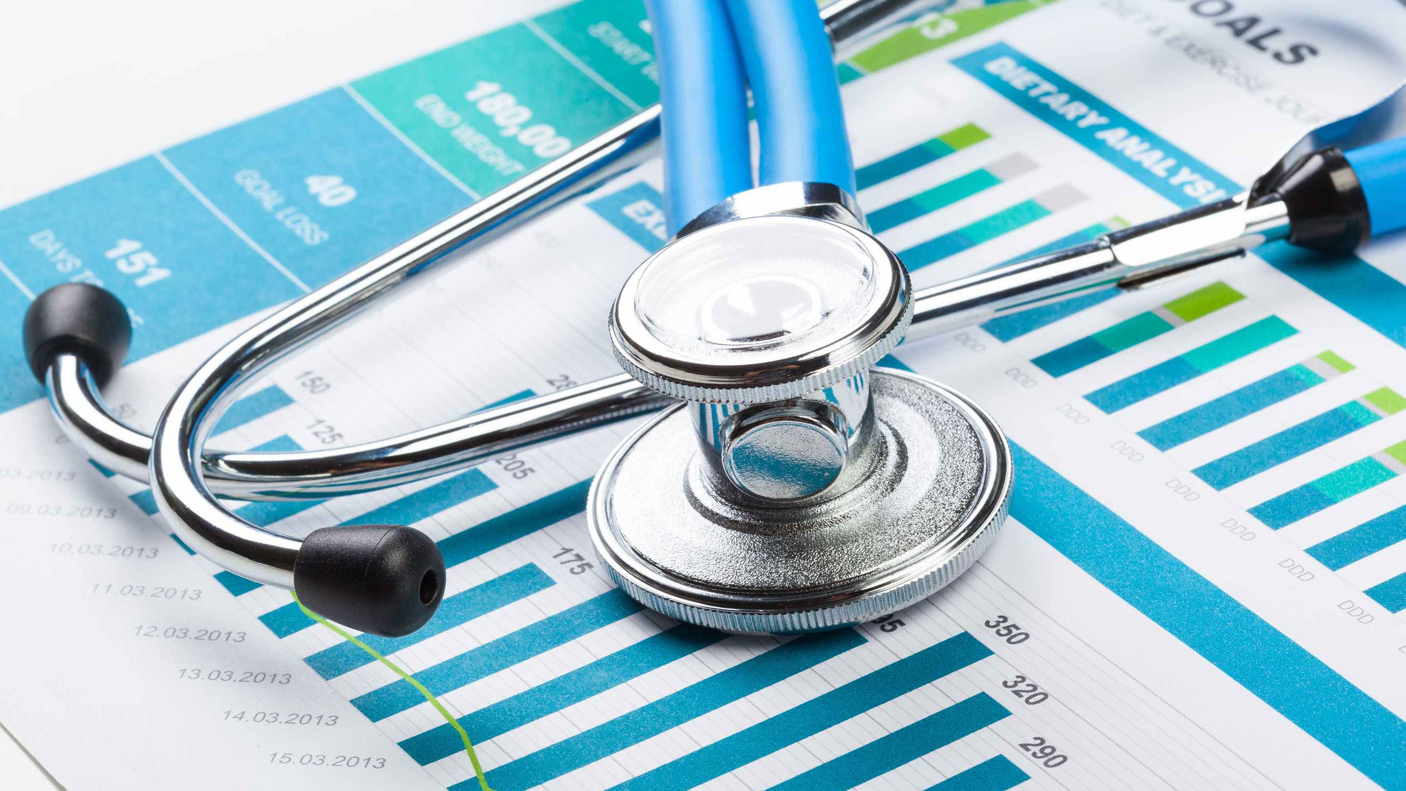 Stethoscope sitting on top of health data