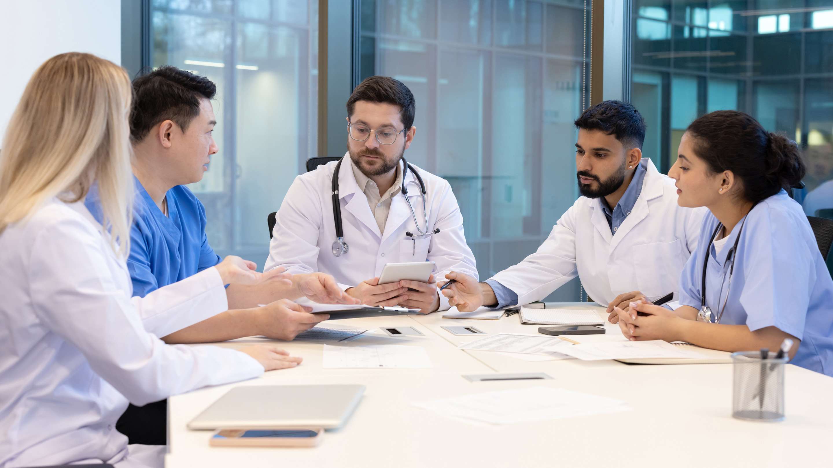 Care team reviews printed data reports and metrics