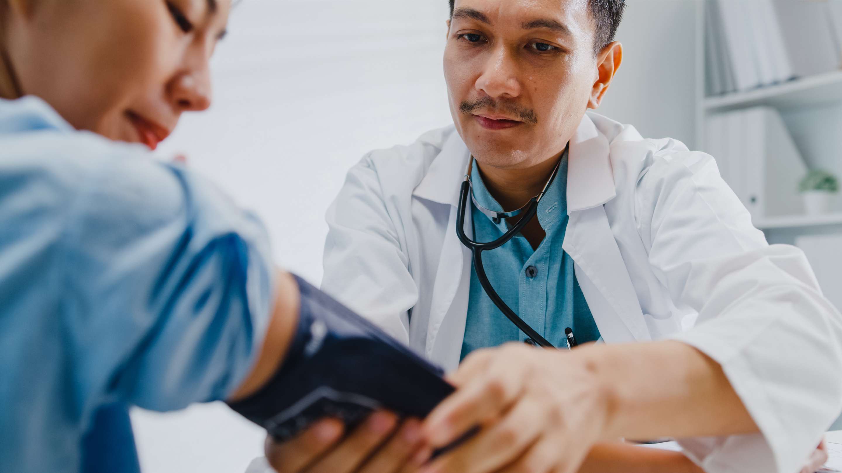 Family physician takes a patient’s blood pressure