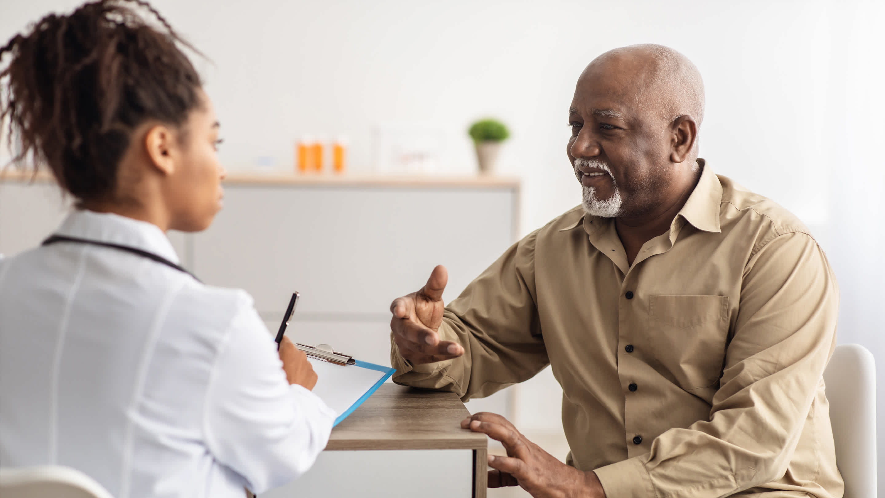 Physician listens to patient during office visit