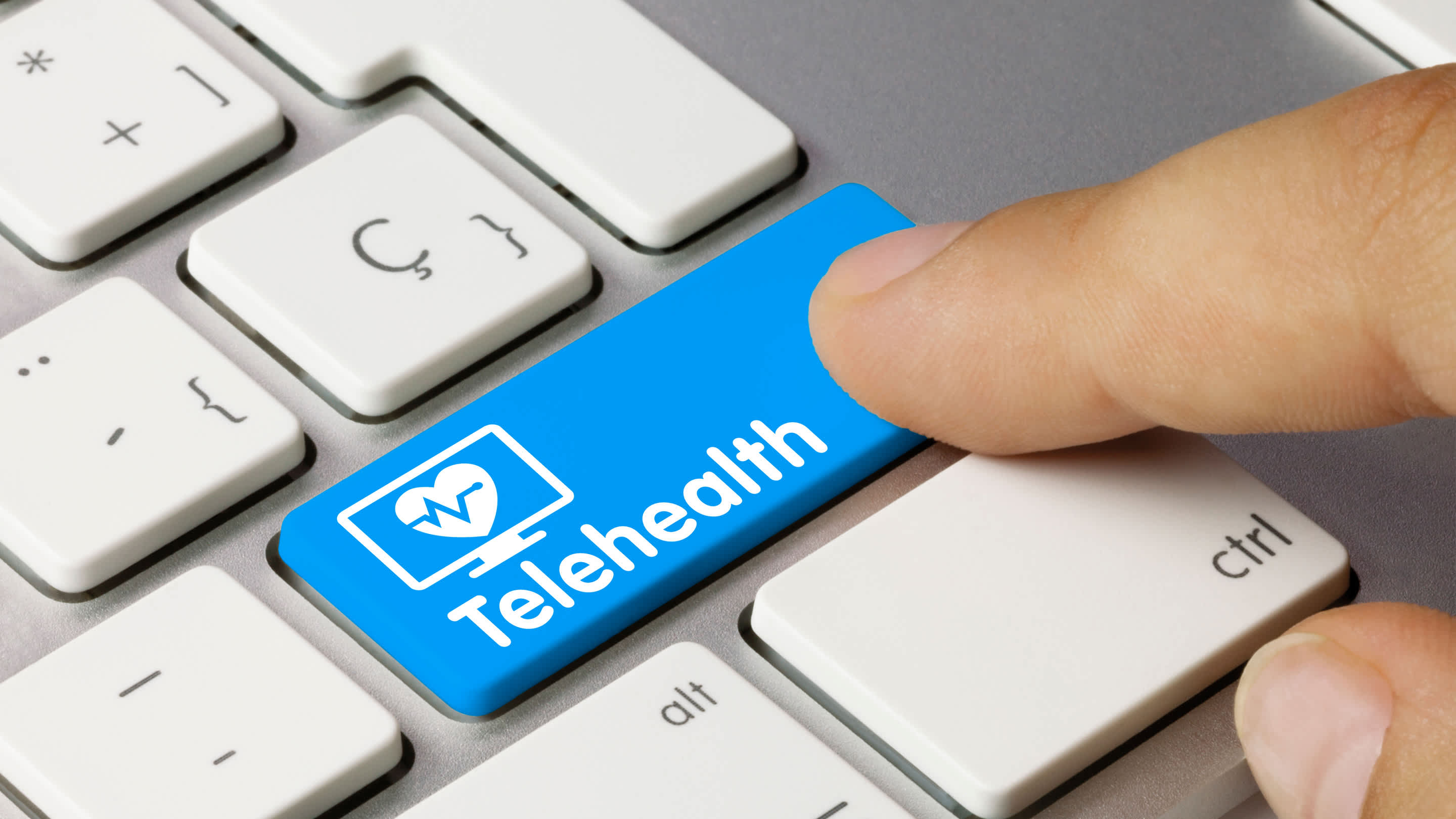 Keyboard with a return key that reads “telehealth”.