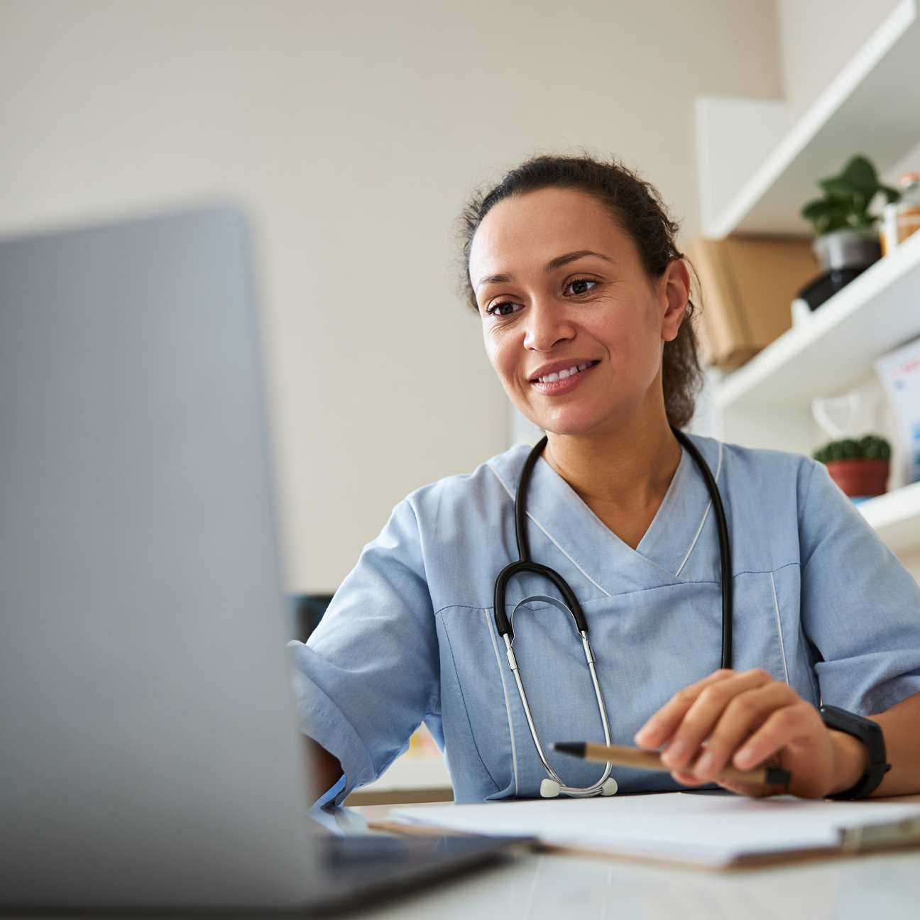 Female physician at a desktop computer.