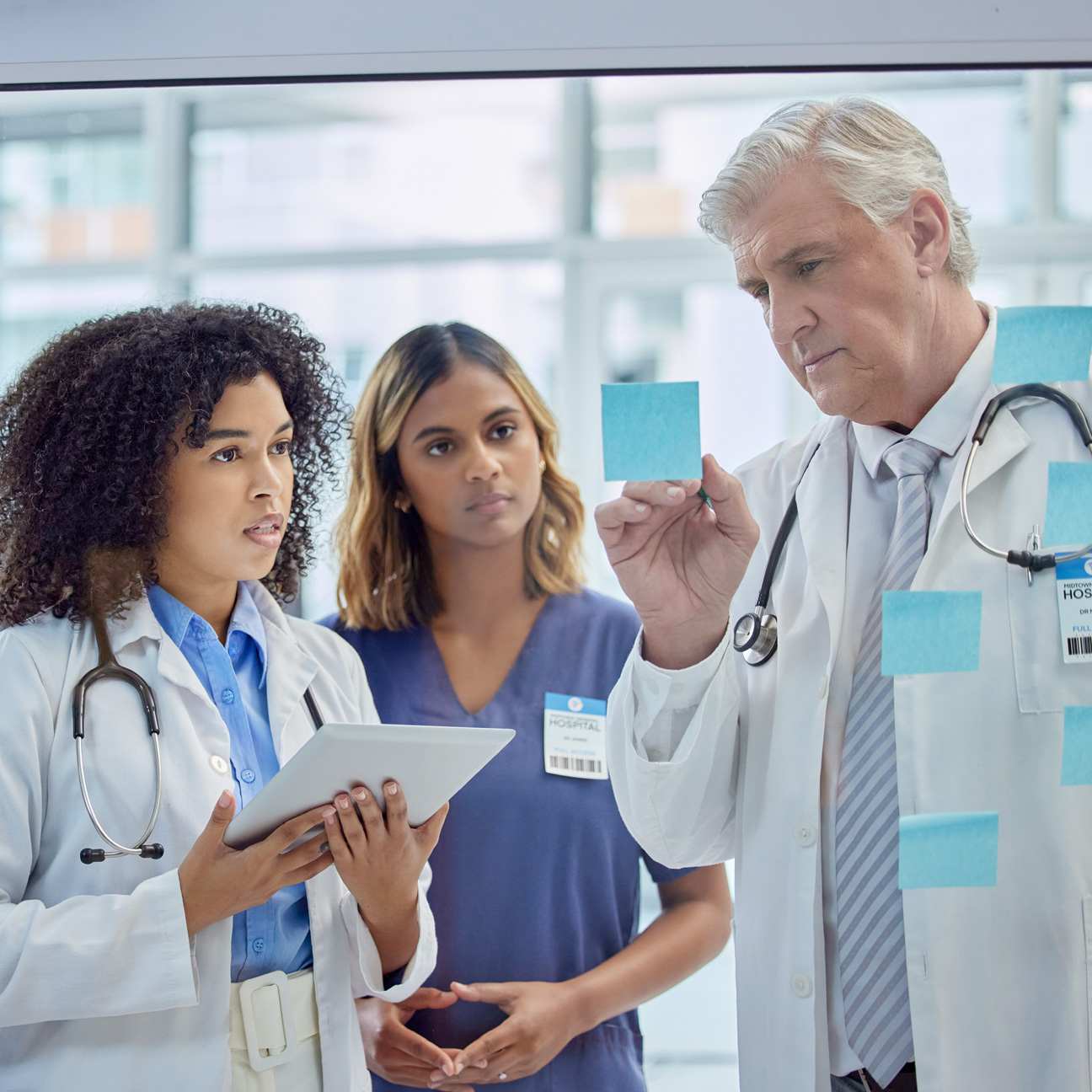 Resident physicians consulting with mentor during hospital rotation