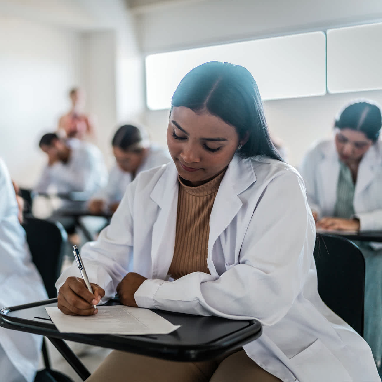 female resident taking a test at a desk