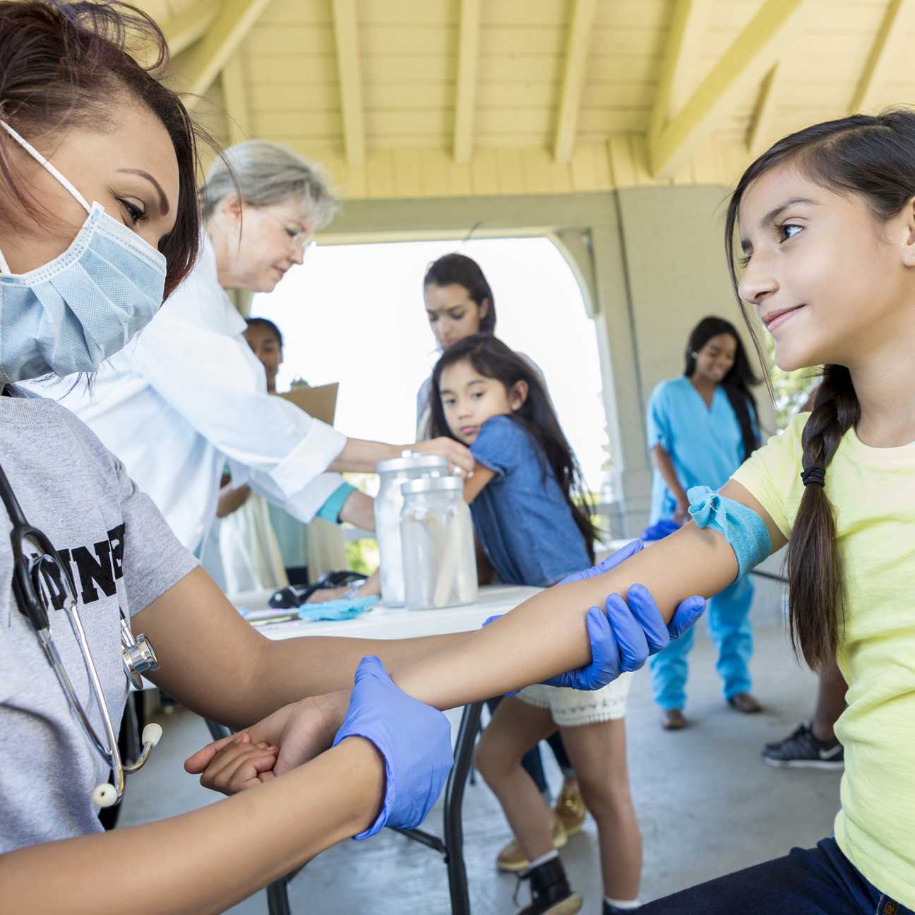 female doctor helping a young female patient on a mission trip