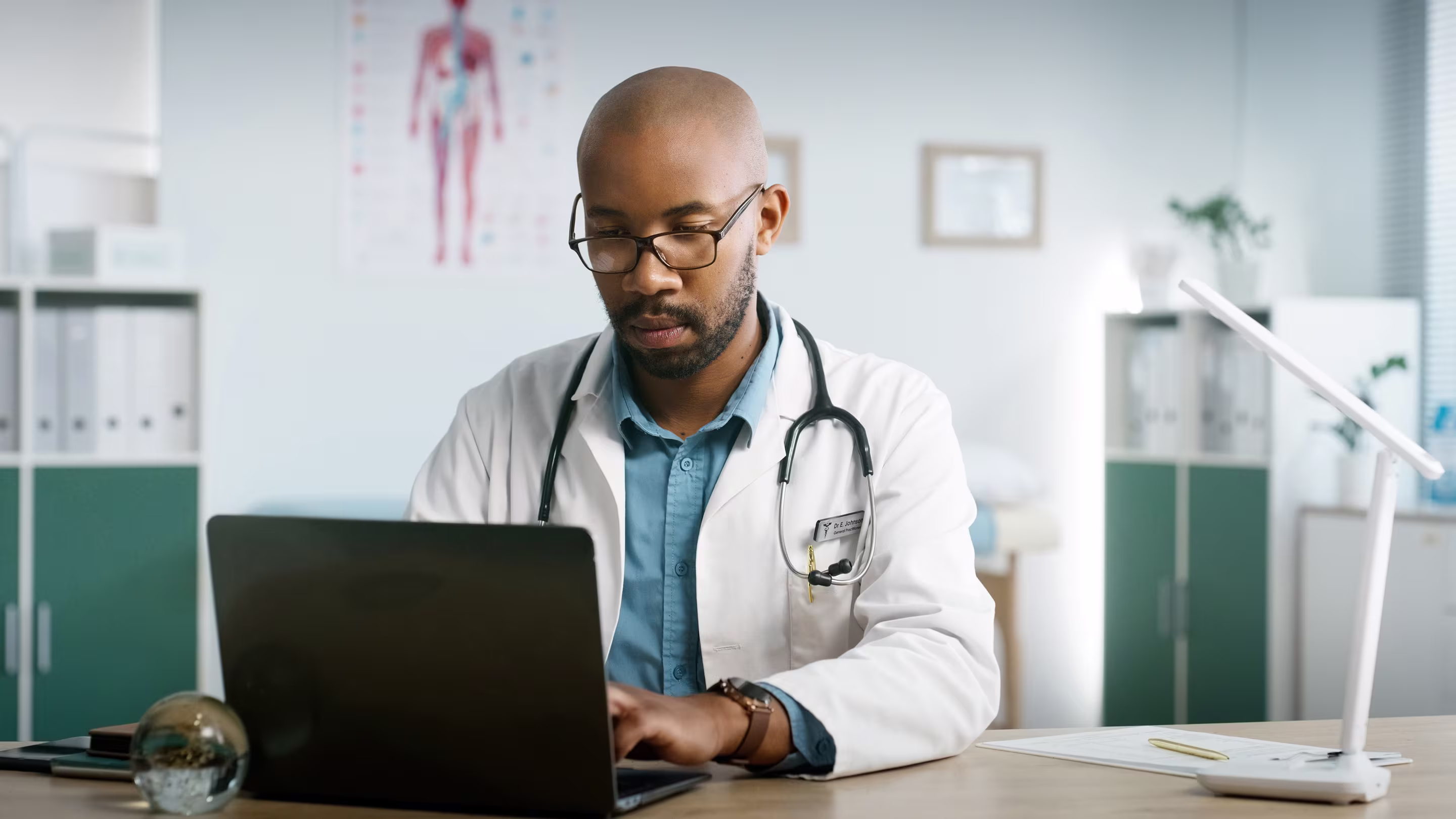 Image of Family Physician logging into the Member Portal on his laptop.