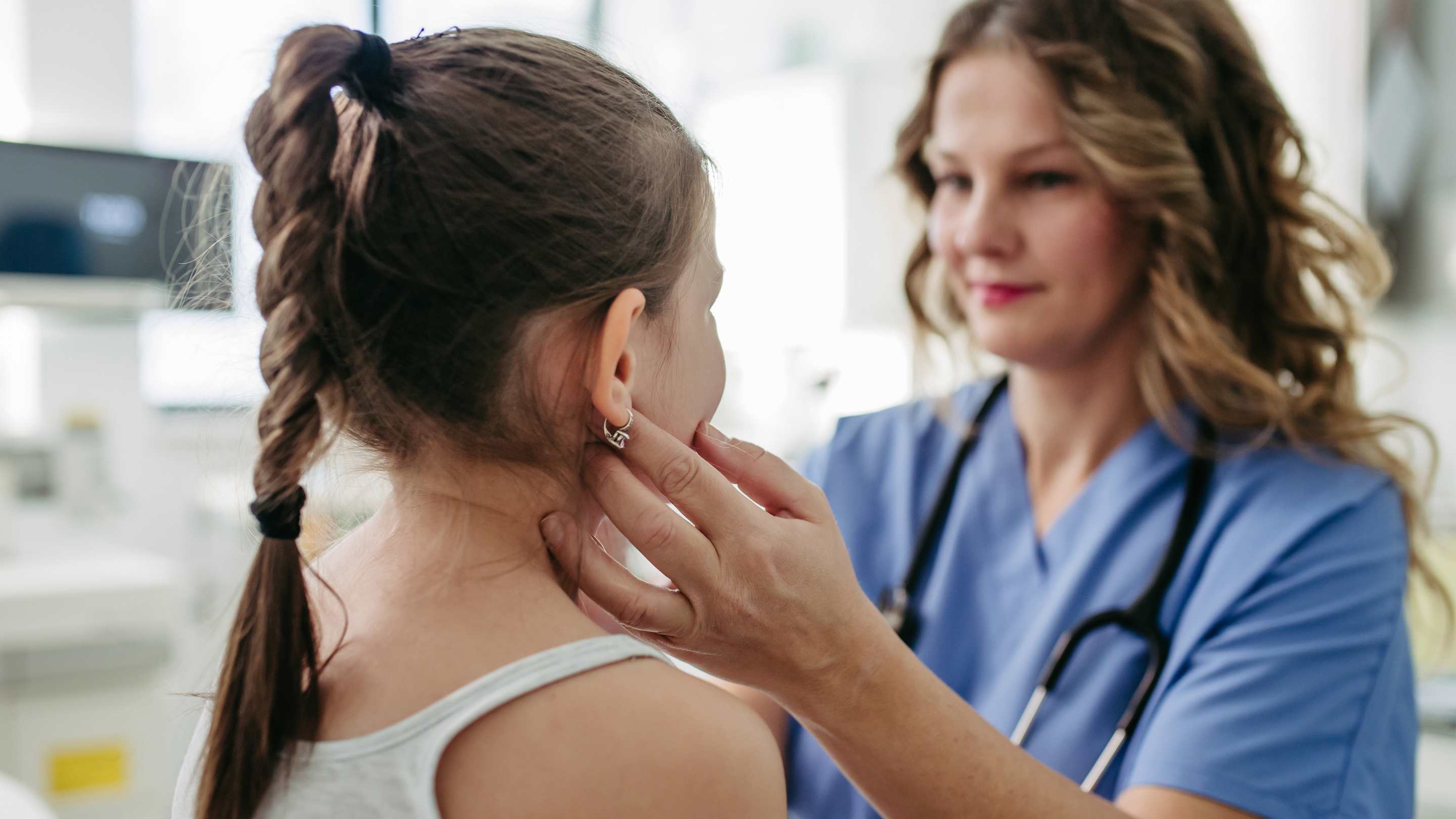 A family physician performing an exam on a child