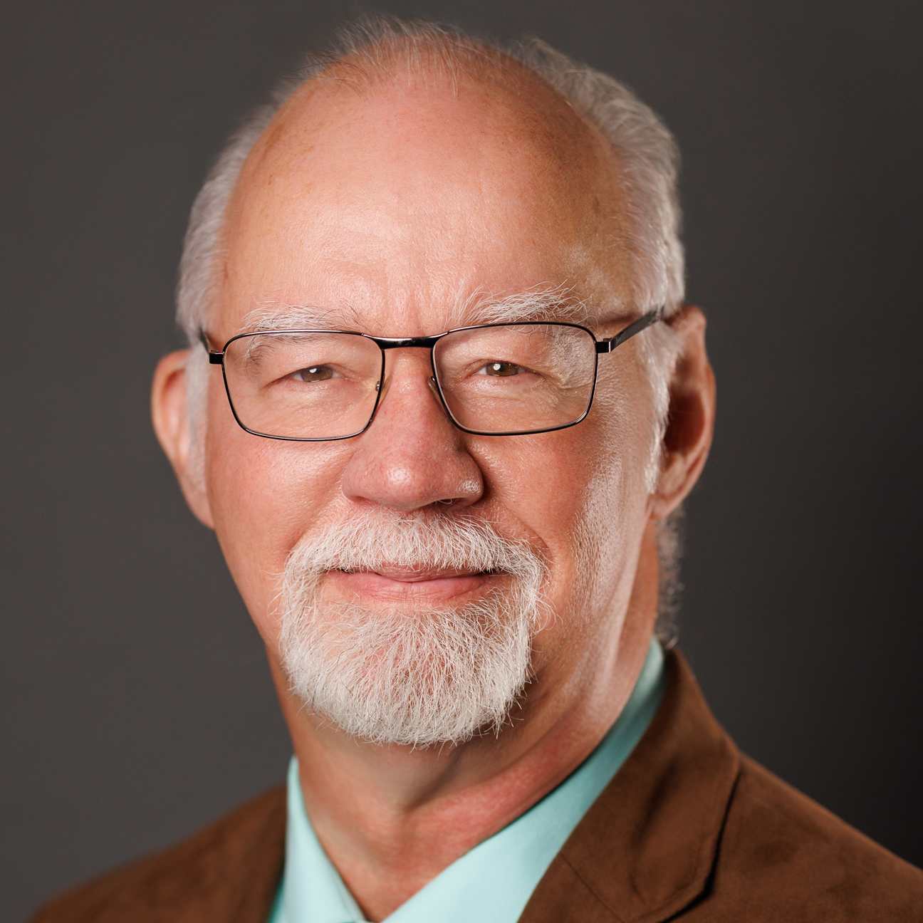 A smiling man with glasses.