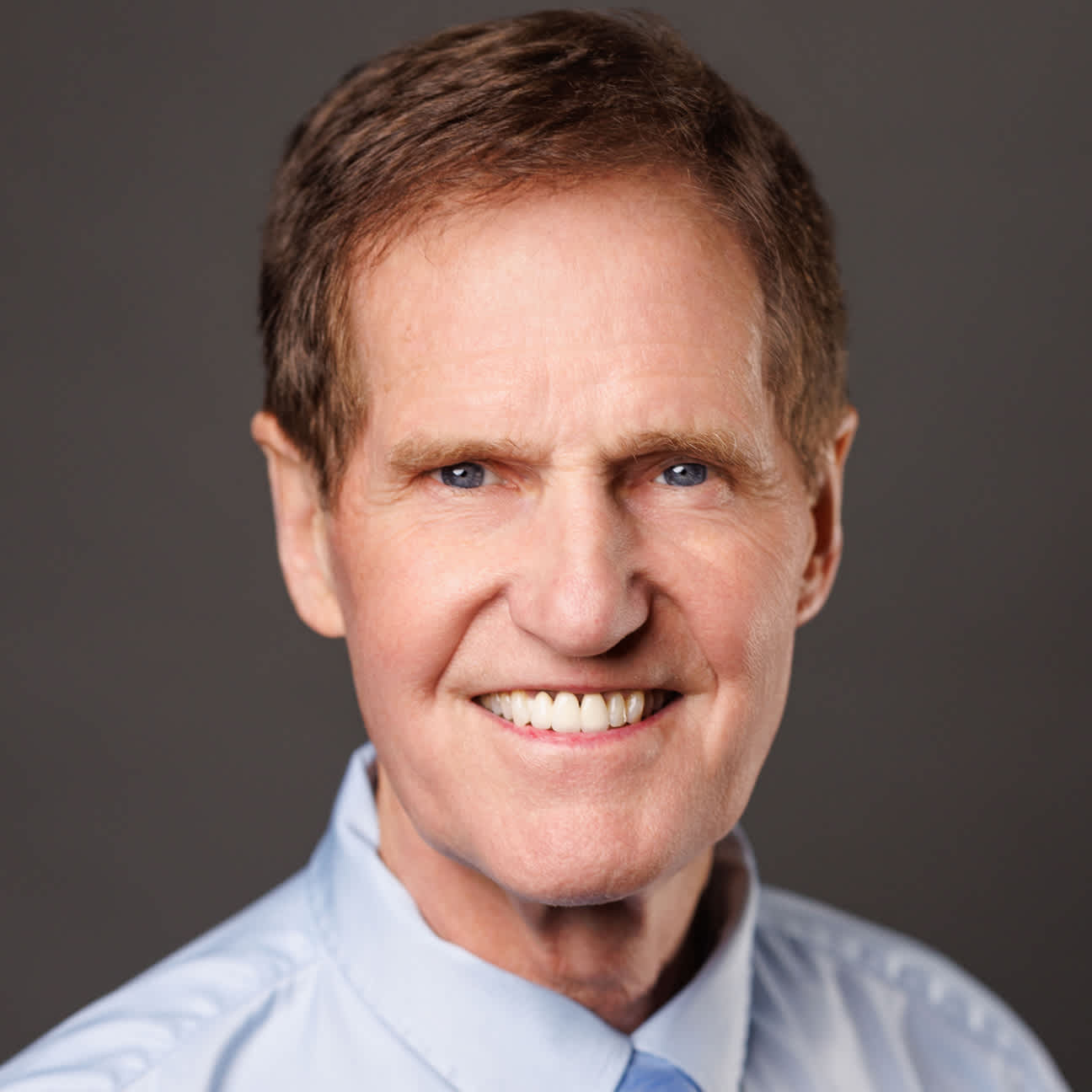 A smiling man in a suit.