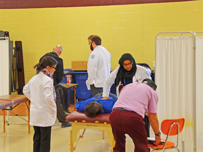Osteopathic medical students from A.T. Still University's Kirksville College of Osteopathic Medicine treat an Amish patient during a free health fair put on by Still Caring Health Connection-Volunteers in Medicine.