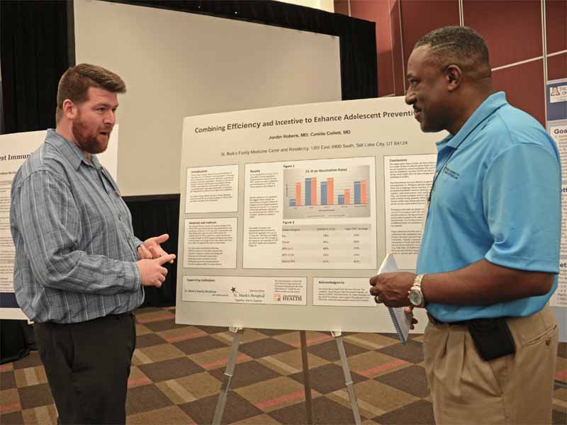 Poster award winner Jordan Roberts, M.D., left, of the St. Mark's Family Medicine Residency in Salt Lake City, explains his project to Eddie Richardson, M.D., Board Chair of the Georgia AFP.