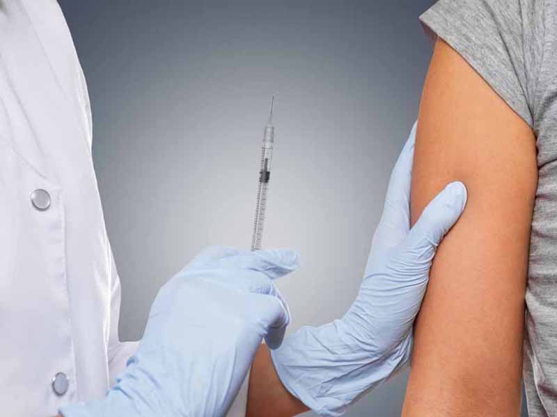 clinician preparing to administer vaccine