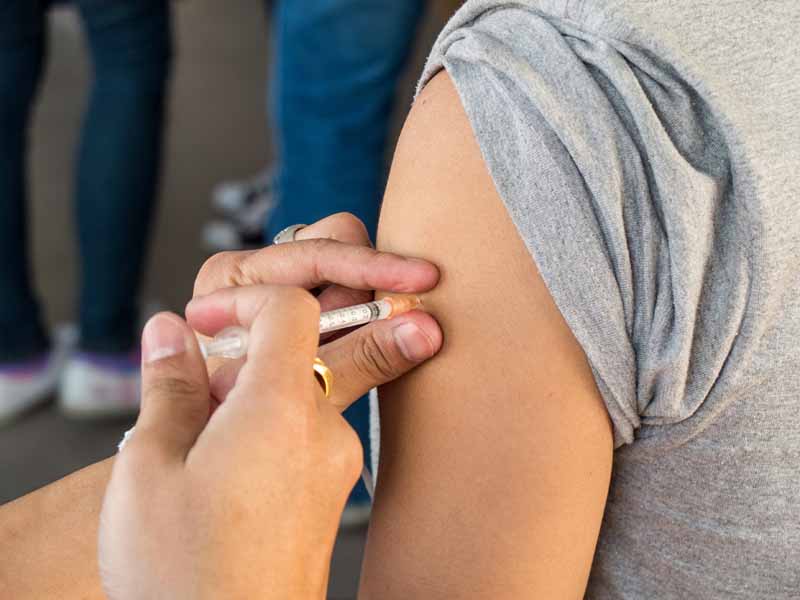 arm of adolescent receiving vaccination