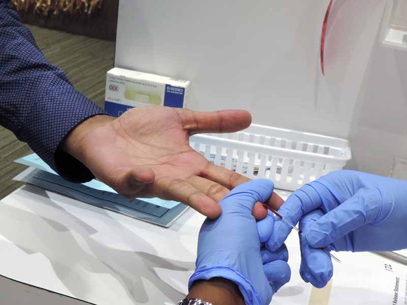 clinician performing fingerstick testing