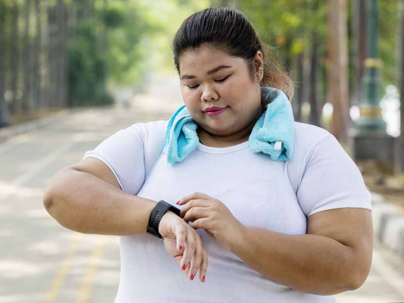 exercising woman checking smartwatch