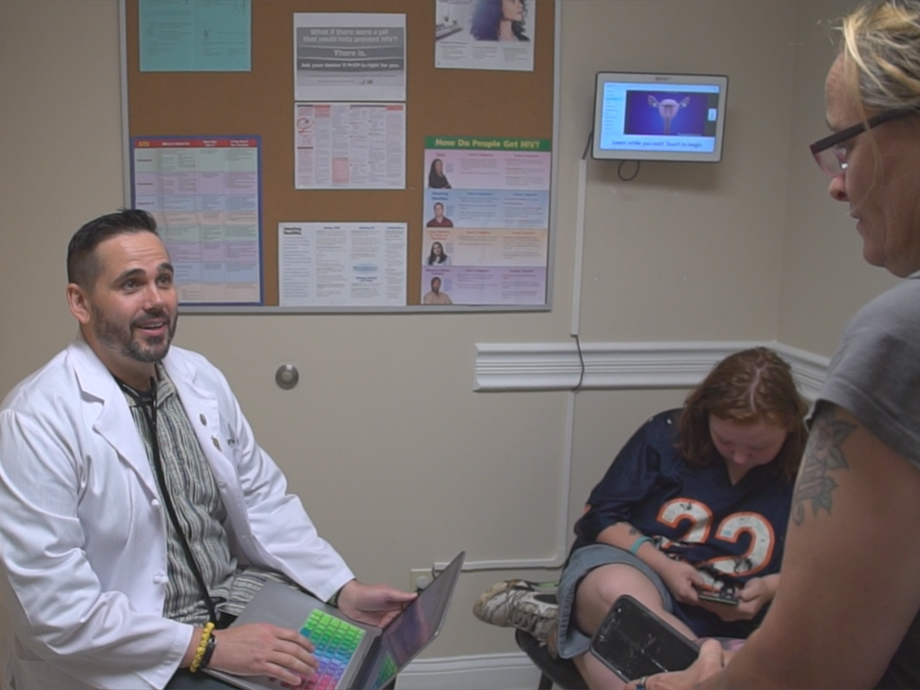 2019 FPOY Will Cooke, M.D., with a patient in the exam room