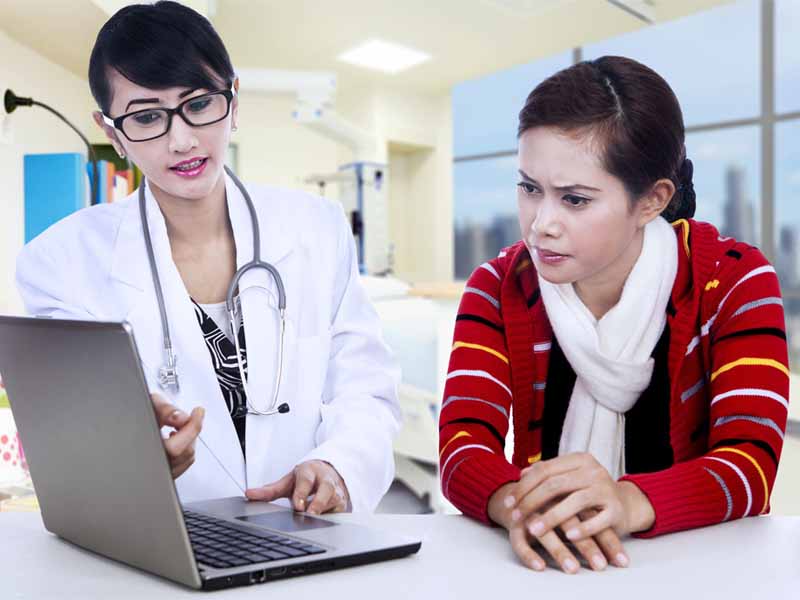 female physician talking with teenage girl