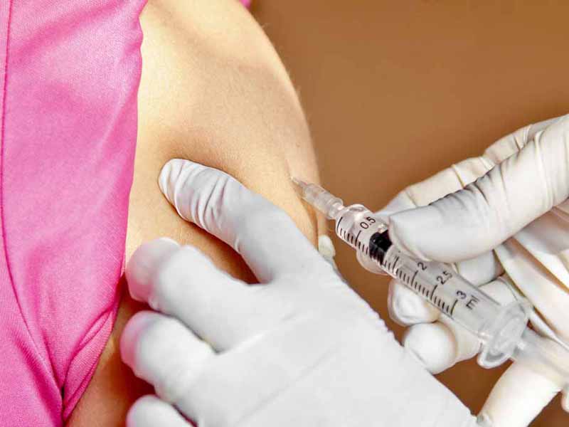 Clinician administering influenza vaccine dose