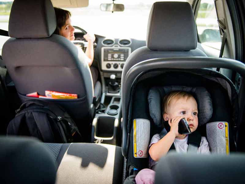 infant sitting in car seat in vehicle