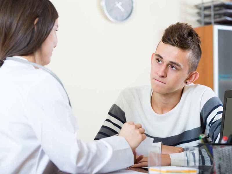 adolescent boy speaking with clinician
