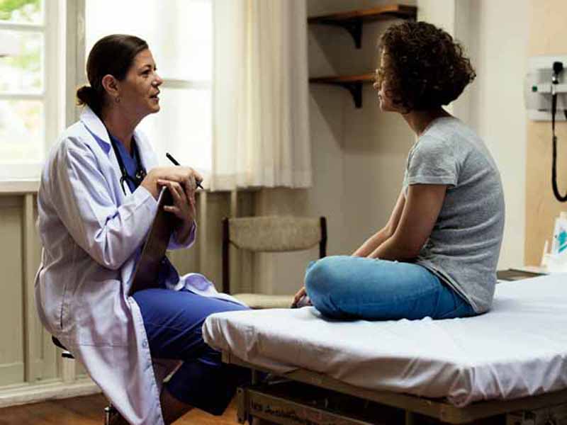 physician talking with young patient
