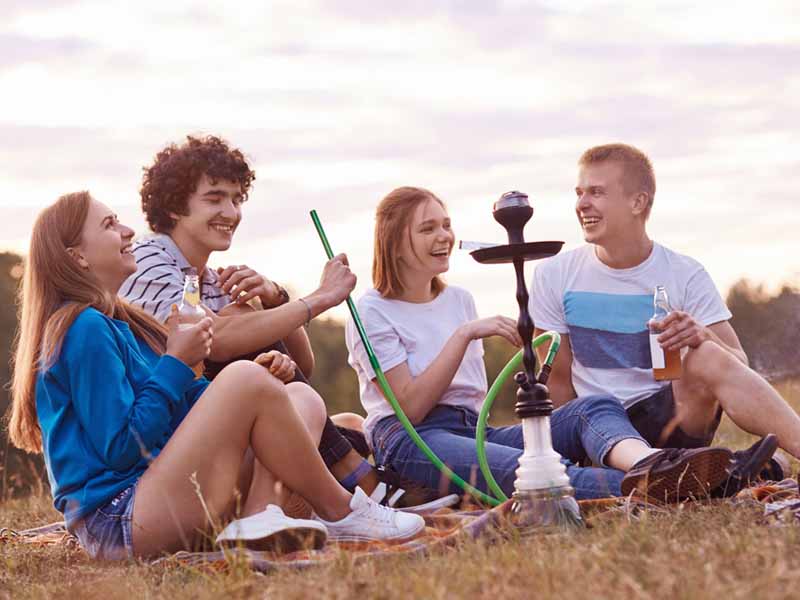 Group of teens smoking a hookah