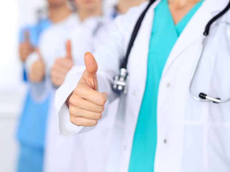 Group of doctors showing thumbs up