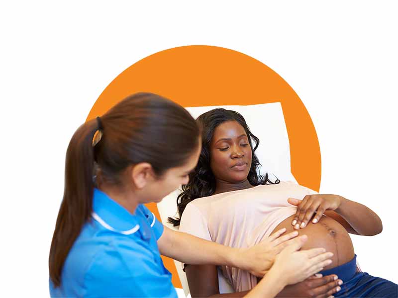 a female doctor checks on a pregnant woman's stomach