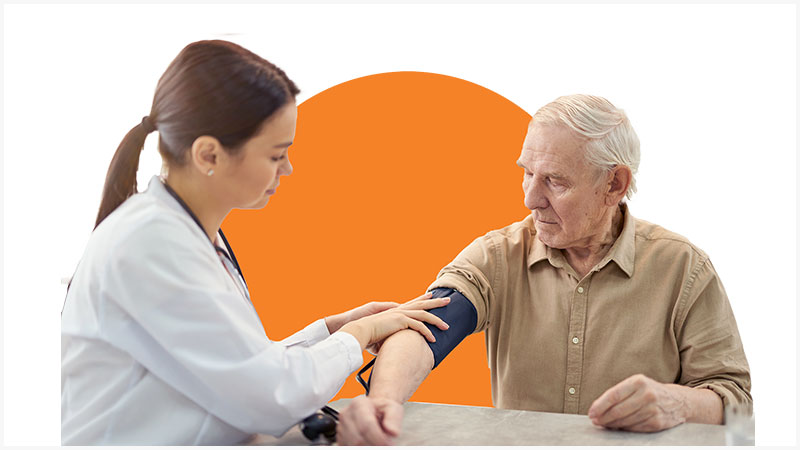 a female doctor checks an older man's blood pressure
