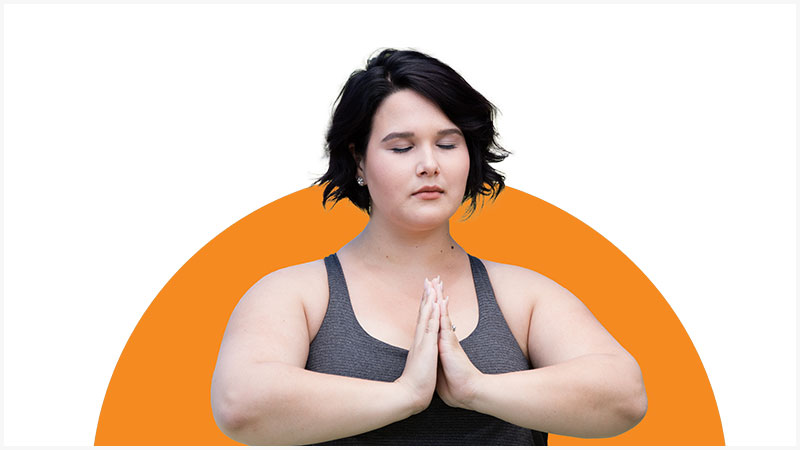 Woman in yoga pose with hands pressed together