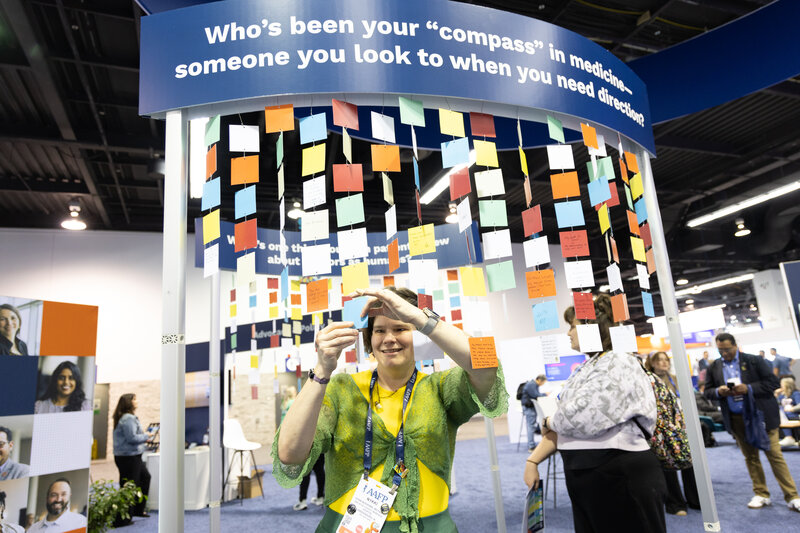 Female doctor looking at display on expo hall