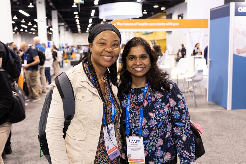 Two women standing in expo hall