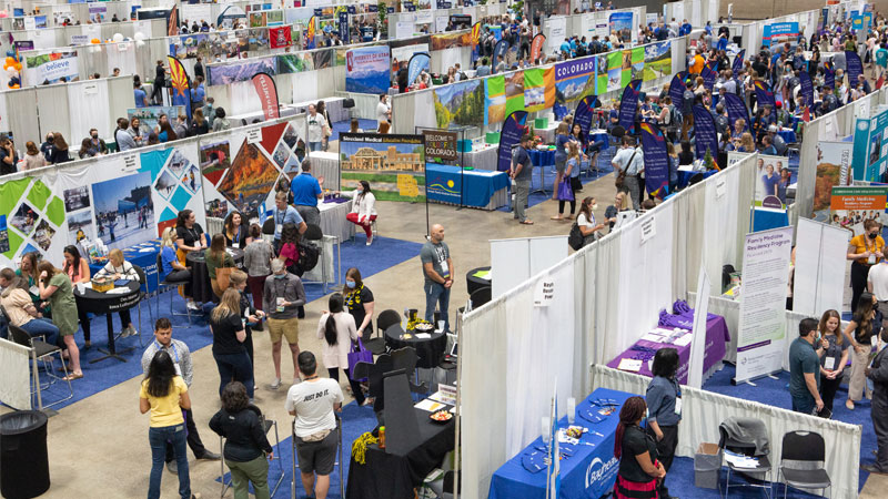 View of the Expo Hall at the convention center with people in each booth.