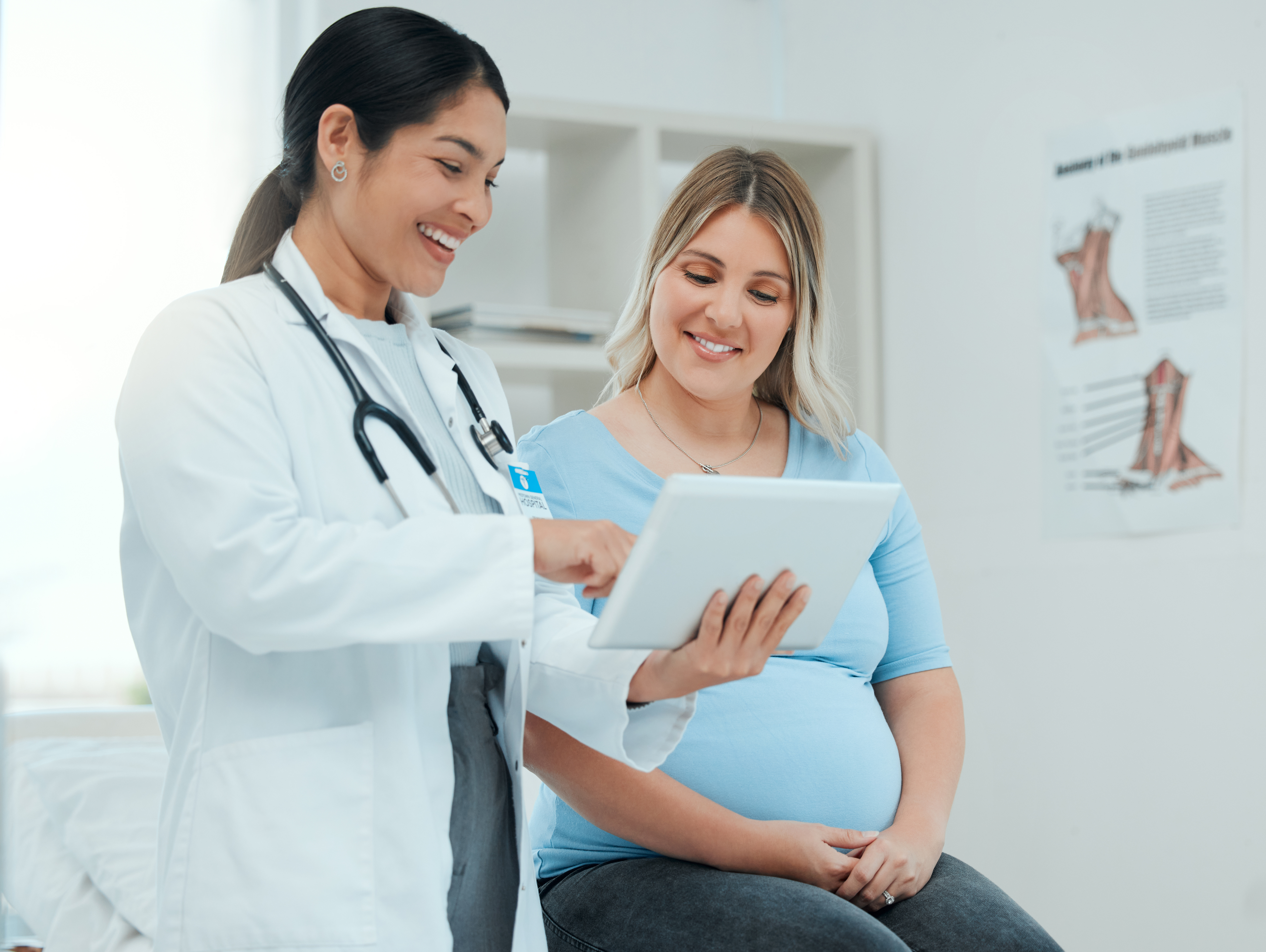 Healthcare, tablet and pregnant woman at a prenatal consultation for health in a medical clinic. Wellness, maternity and female pregnancy doctor speaking to a mother with a digital mobile in hospital.