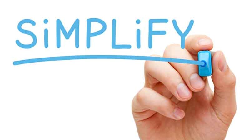 Hand writing "simplify" in blue marker