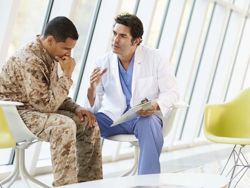 physician talking with soldier