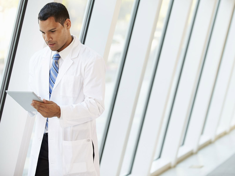 physician looking at website on tablet