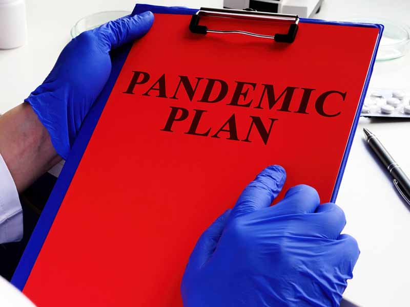 physician holding pandemic plan