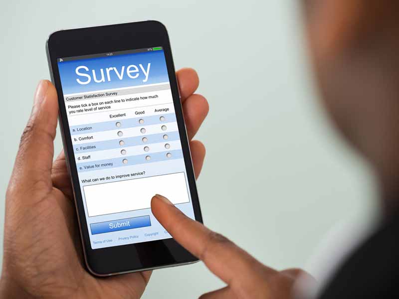 Man completing survey on mobile device